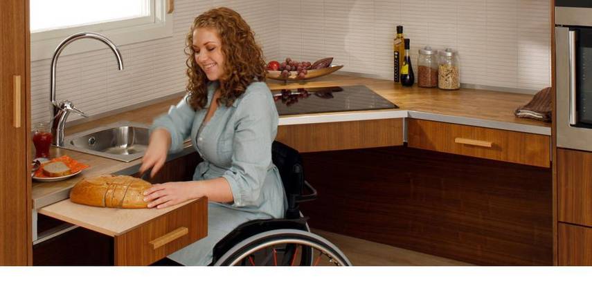 Rollstuhlfahrerin in einer barrierefreien Küchen