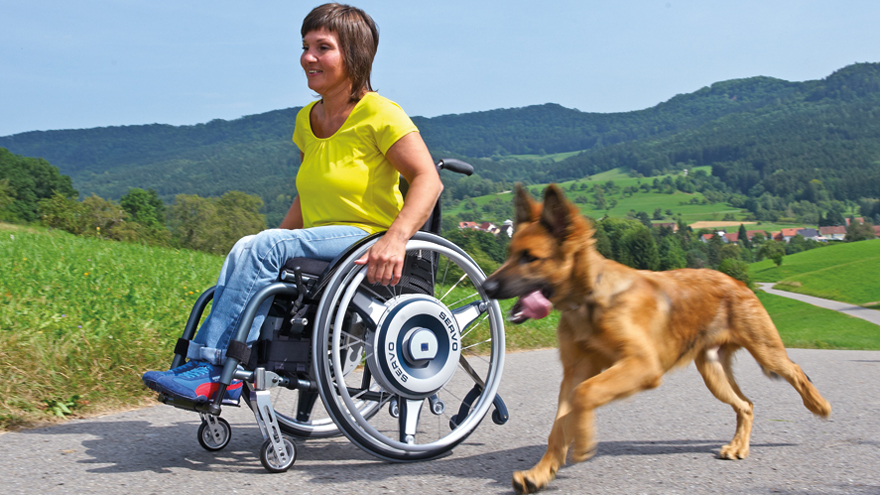 Abbildung: junge Frau mit Rollstuhl und Hund (Fa. AAT Alber)